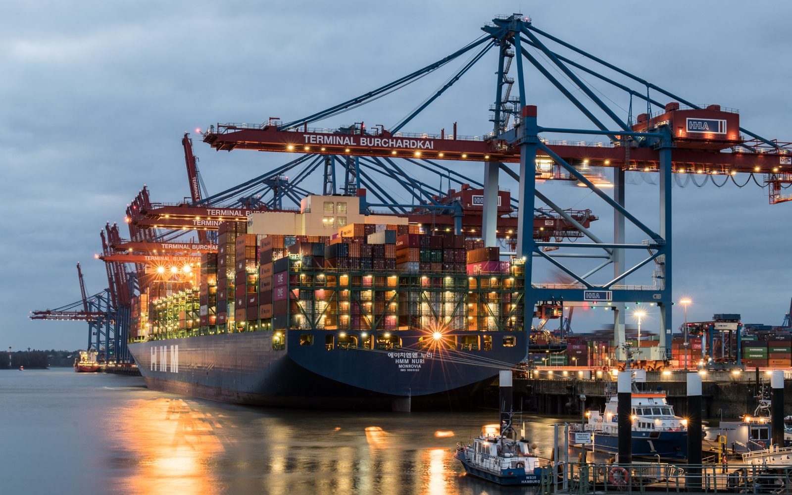 Container ship being loaded at a port